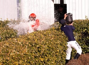 Darius Thorpe gets the traditional first-win bath. Photo by Jim McCue, Maryland Jockey Club.