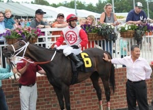 Horacio Karamanos and the man he calls "like a father," Carlos Garcia, smile after Saintly Love's win in the Old Nelson.  Photo by Nick Hahn.