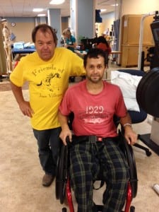 Maryland Horsemen's Assistance Fund Executive Director Bobby Lillis visits with injured exercise rider Jose Villegas.