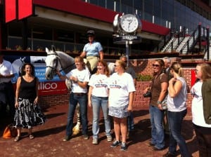 Stud Muffin, along with his people, hams it up in the Pimlico winner's circle.