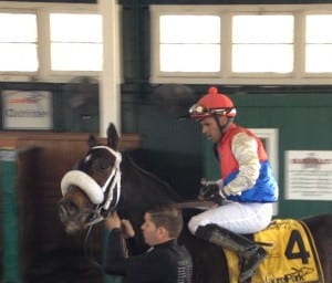 An exhausted Victor Santiago takes Behemoth back for the win photo following the Campbell.  Photo by The Racing Biz.