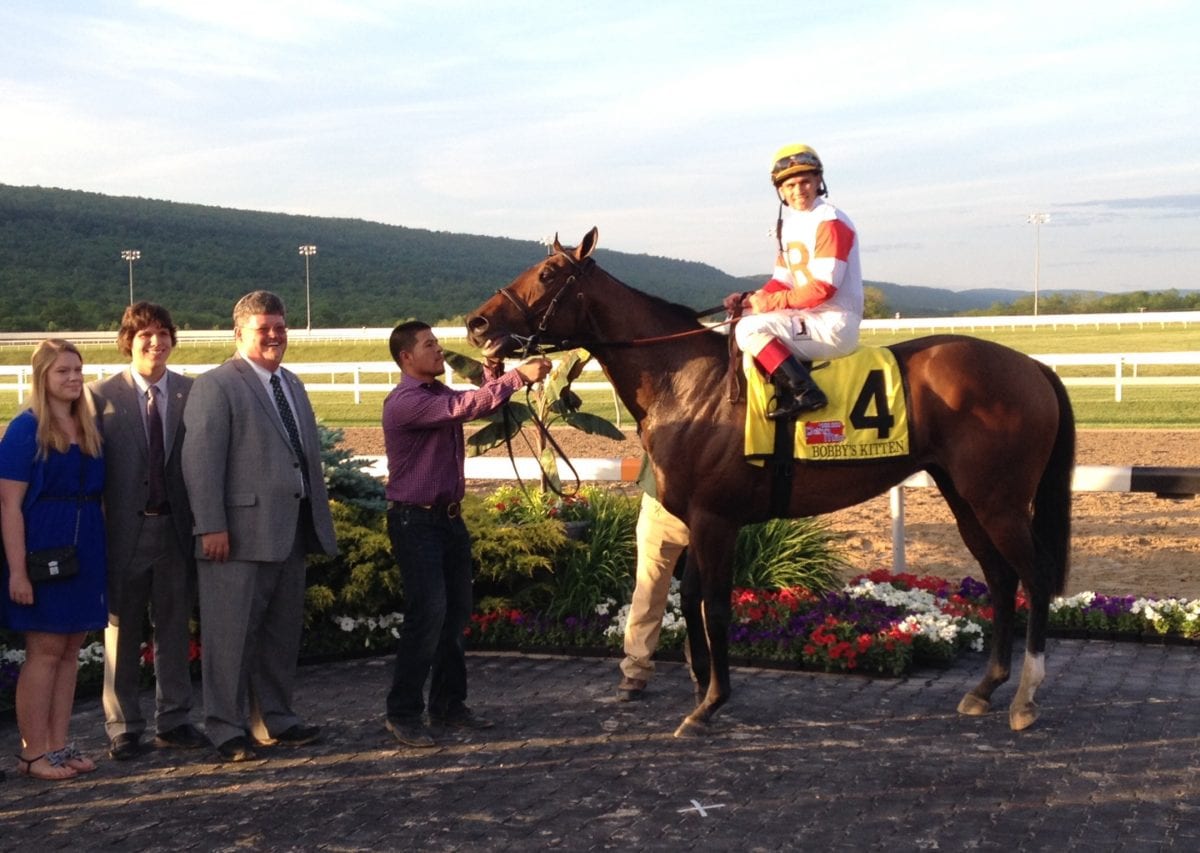 Stephanie, William, and Jeff Ramsey smile for victorious Bobby's Kitten after the Penn Mile. Photo by The Racing Biz.