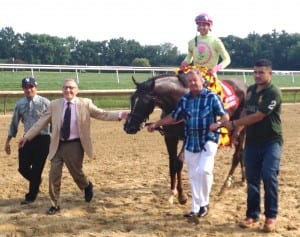 Mike Caruso (in tie) and Rudy Rodriguez (far left in ball cap) accompany Belle Gallantey after the Delaware Handicap. Jose Ortiz rode.  Photo by The Racing Biz.