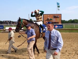 Trainer Edward Graham (in tie) celebrates Hardest Core's Cape Henlopen win.