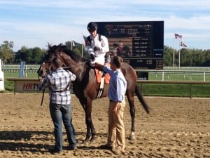 Jockey Forest Boyce and trainer Tres Abbott shake on Nellie Cashman's victory.