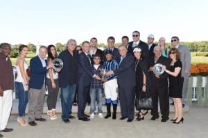 Vosburgh winner's circle. Freddie Velazquez is at right, holding silver plate along with wife Anita. Photo by NYRA.