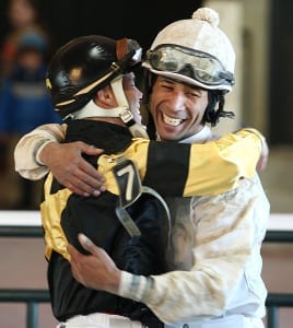 Kendrick Carmouche (right) and John Bisono embrace after dead-heating for the win in the Auld Lang Syne S. Photo By Bill Denver/EQUI-PHOTO 