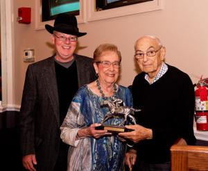 Harold Snyder (right) and wife Marcia smile after receiving his Finney Award from Maryland Racing Media Association president Ted Black. Photo by Ellen B. Pons.