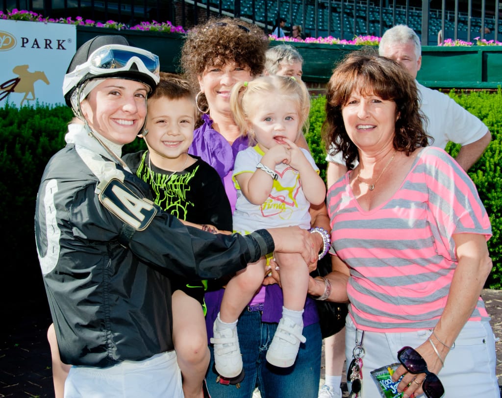 Maria Remedio with son Caleb, daughter Arabella, and mom Patti (at right) after a 2013 victory. Photo by HoofprintsInc.com