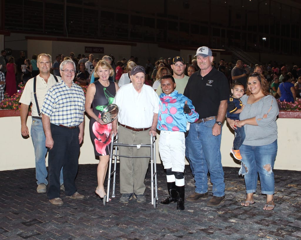 James Casey, center in white shirt, jockey Antonio Lopez, and the gang celebrate Greenway Court's win in the It's Only Money Stakes. Photo by Coady Photography.