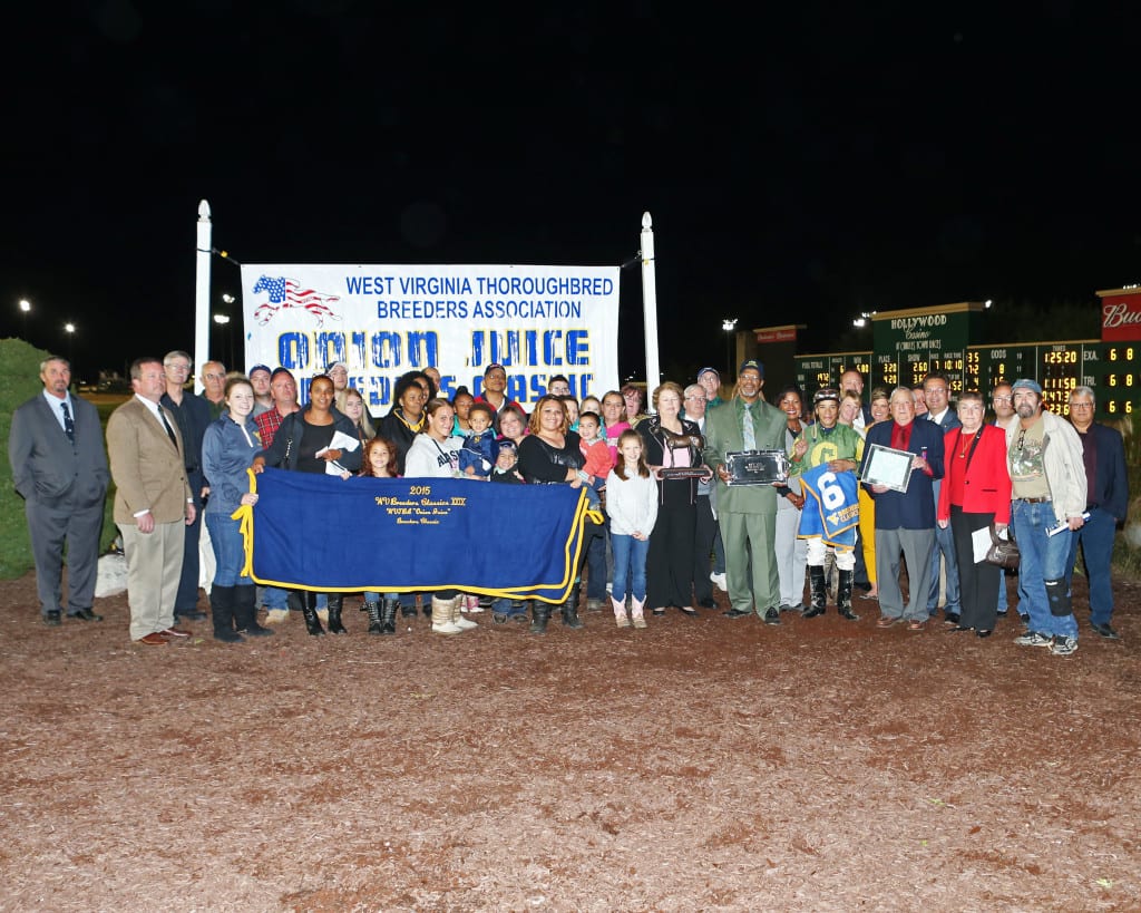 Big crowd celebrates Help a Brother's win in the Onion Juice. Trainer Lewis Craig, Jr. is in the front row, fifth from right, in green suit. Photo by Coady Photography.